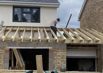 New roof joists being fixed over a front extension