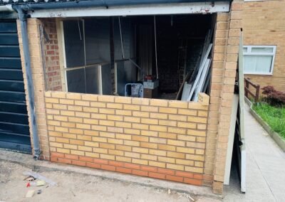 New brick front wall with window opening on a garage conversion