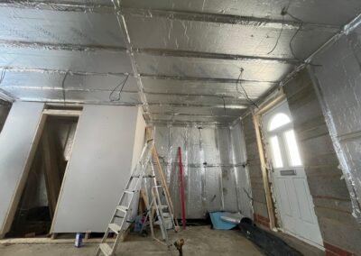 Garage conversion with foil-backed insulation to walls and ceiling