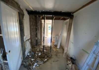 Load-bearing wall removed with temporary props for a new steel beam