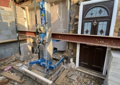 Steel beam being lifted into position with a material lift